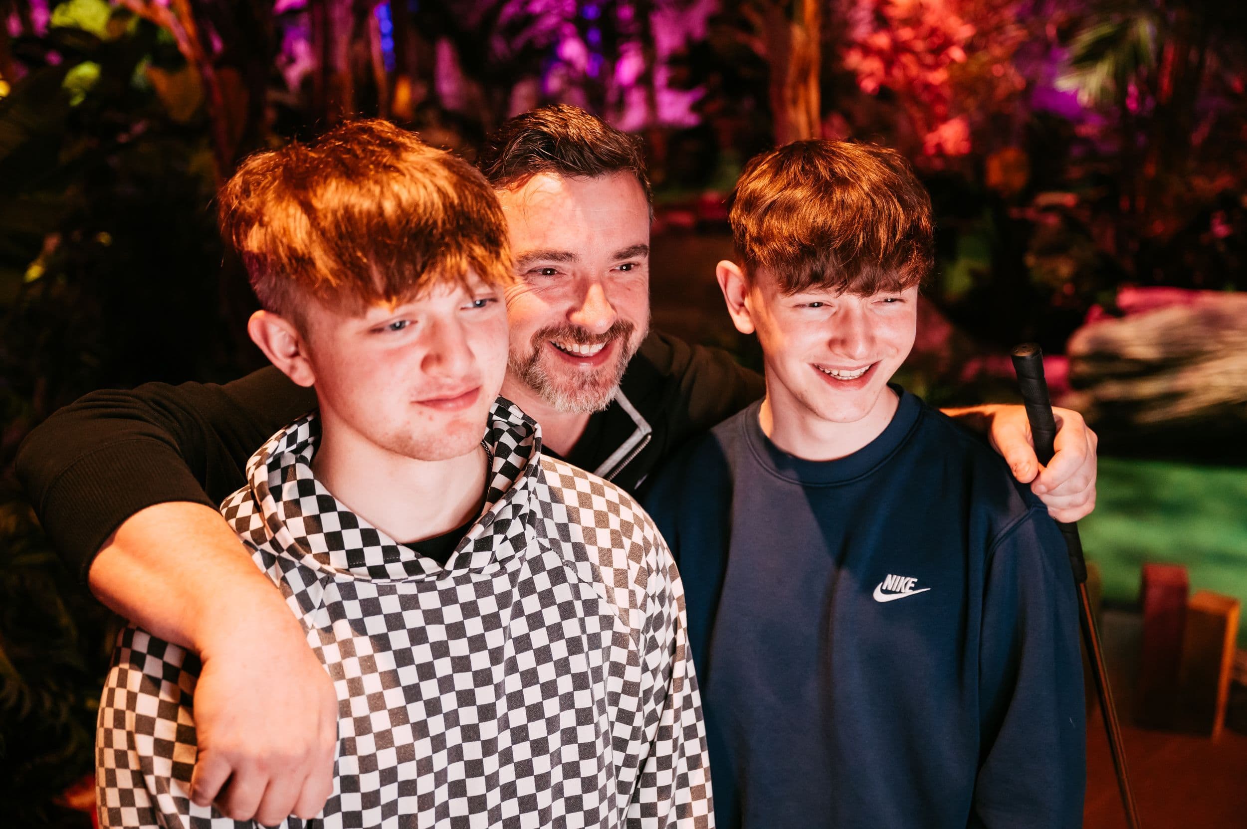 Dad poses with his two sons for a photo.