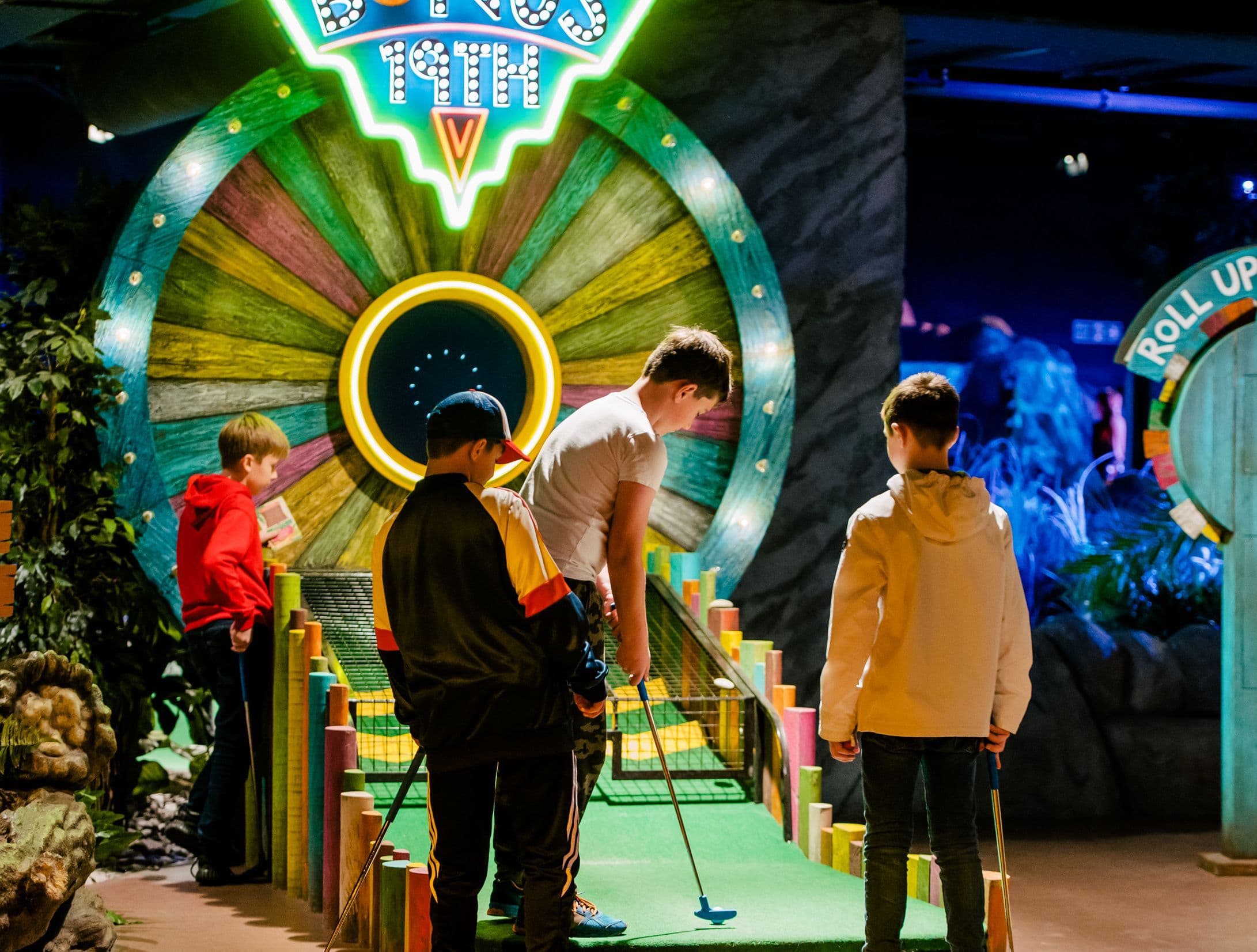 4 children putting on the 19th hole.